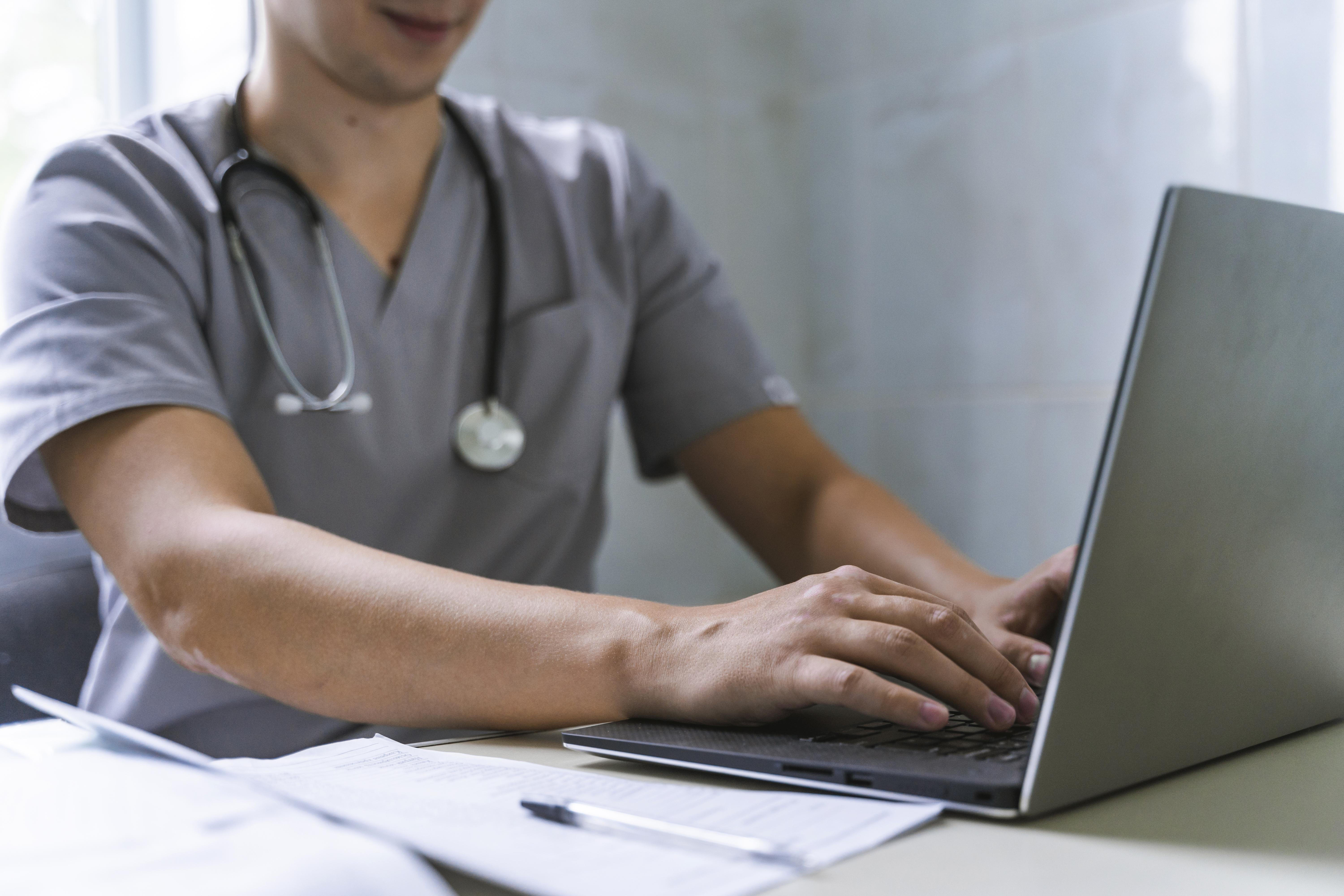 side-view-doctor-with-stethoscope-working-laptop.jpg